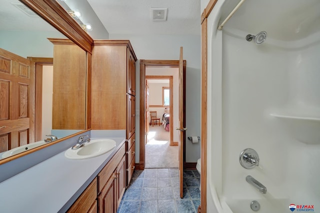 bathroom with vanity and washtub / shower combination