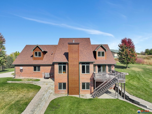 rear view of house featuring cooling unit, a yard, and a wooden deck