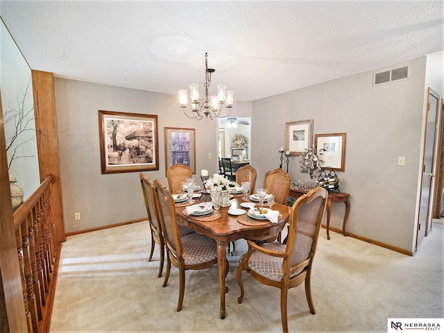 carpeted dining room featuring a textured ceiling and a chandelier