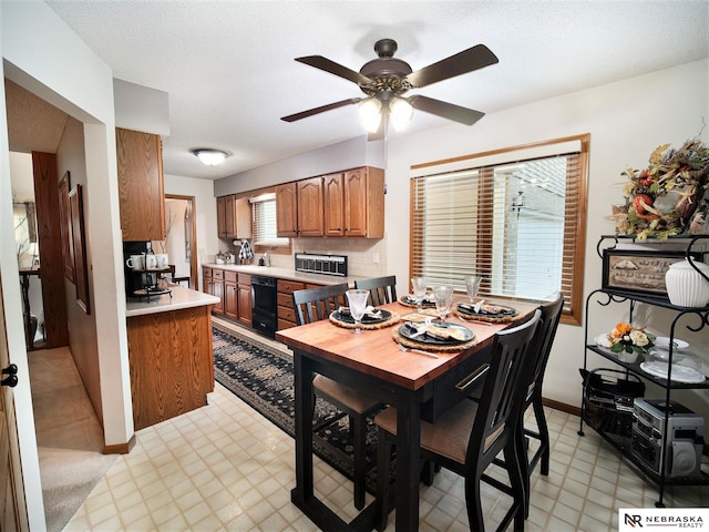 dining room featuring ceiling fan and a textured ceiling