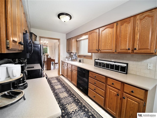 kitchen featuring stainless steel appliances, a textured ceiling, sink, and backsplash