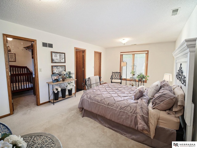 carpeted bedroom with a textured ceiling