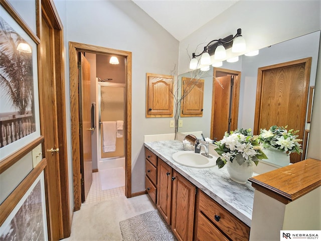 bathroom with walk in shower, vaulted ceiling, and vanity