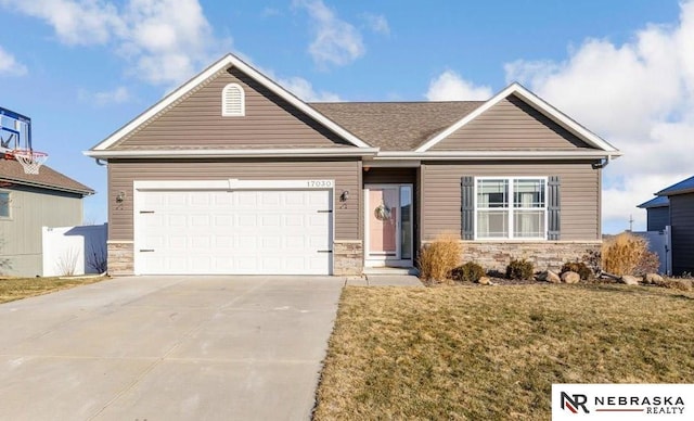 ranch-style house with a front yard and a garage