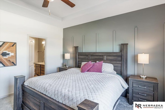 bedroom featuring ceiling fan, light colored carpet, and connected bathroom