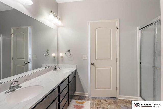 bathroom with a shower with door and vanity