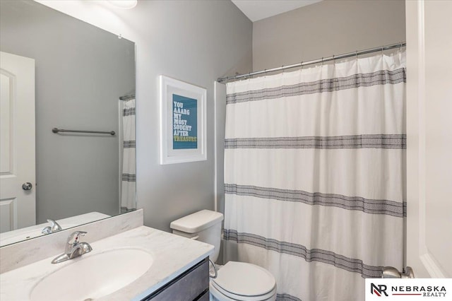 bathroom featuring toilet and vanity