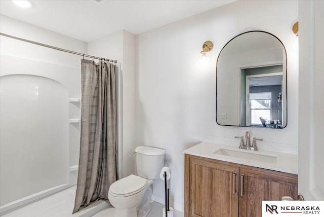 bathroom featuring toilet, vanity, and curtained shower