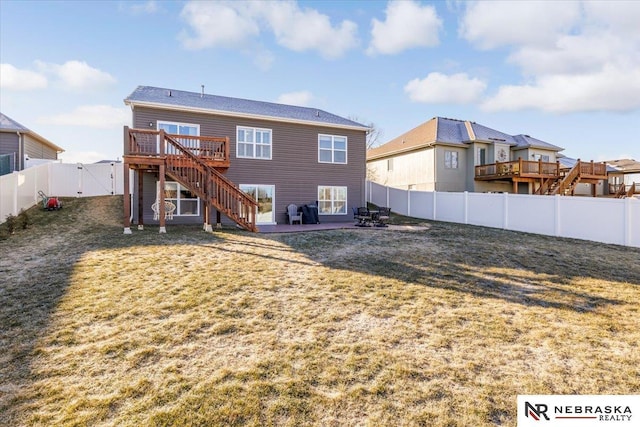 back of property featuring a patio area, a yard, and a wooden deck