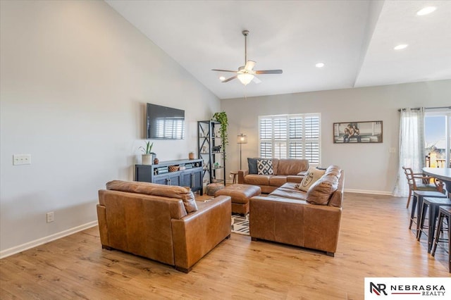 living room featuring high vaulted ceiling, ceiling fan, and light hardwood / wood-style floors