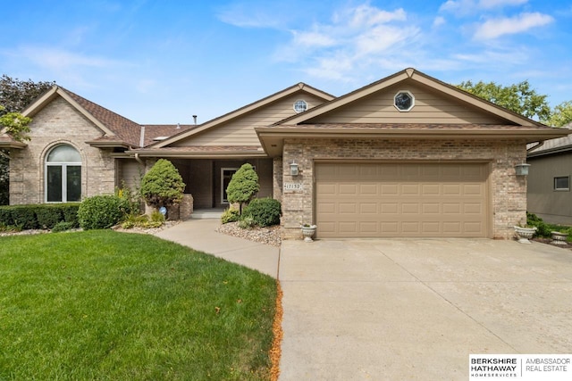 ranch-style house featuring a front yard and a garage