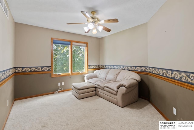 carpeted living room featuring ceiling fan