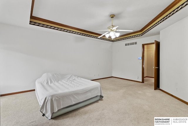 bedroom featuring a raised ceiling, light carpet, ceiling fan, and crown molding