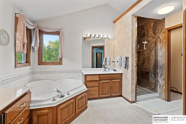 bathroom featuring lofted ceiling, vanity, and independent shower and bath