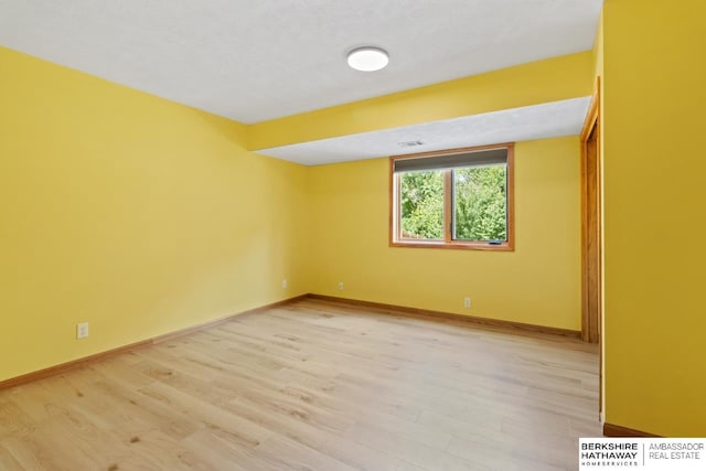 spare room with light wood-type flooring