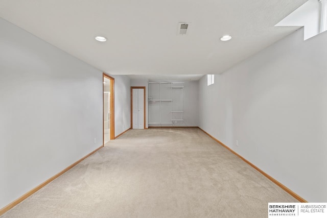 basement featuring light colored carpet