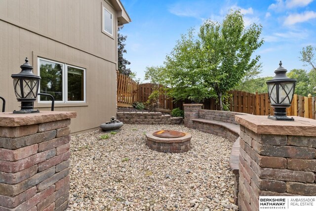 view of yard featuring an outdoor fire pit and a patio area