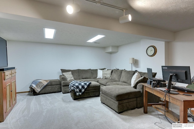 carpeted living room with a textured ceiling and rail lighting