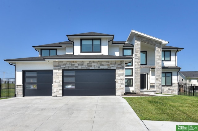 view of front of home with a front lawn and a garage