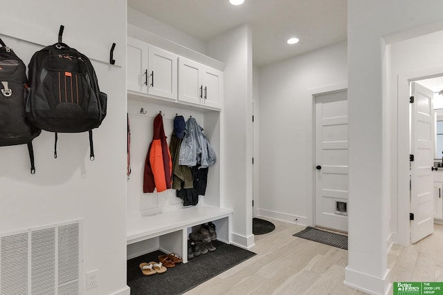 mudroom with light hardwood / wood-style floors