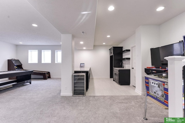 interior space featuring light carpet and wine cooler