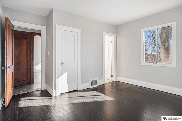 unfurnished bedroom featuring dark wood-type flooring