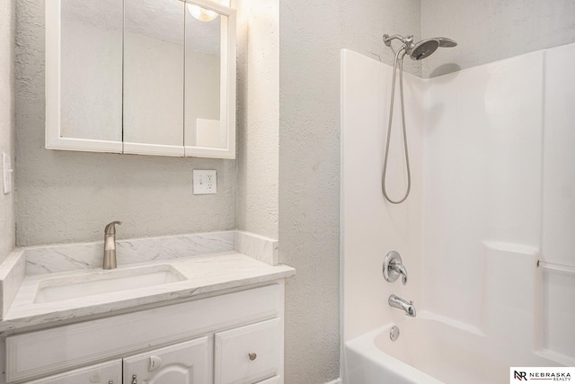 bathroom with vanity and shower / bathing tub combination