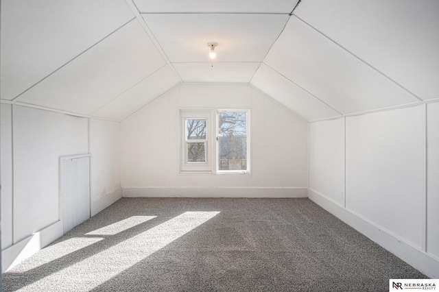 bonus room featuring vaulted ceiling and carpet