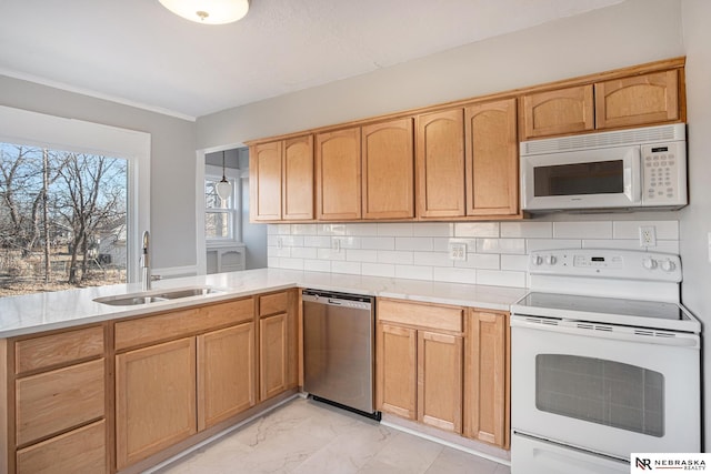 kitchen with tasteful backsplash, sink, and white appliances