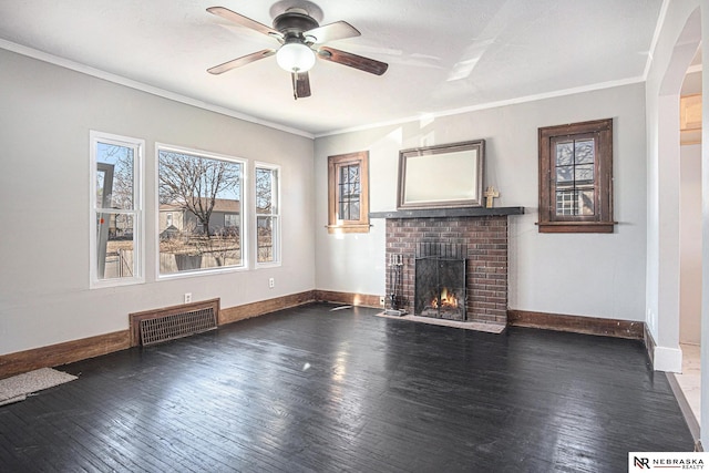 unfurnished living room with crown molding, ceiling fan, dark hardwood / wood-style floors, and a brick fireplace