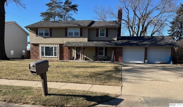 view of front property featuring a garage and a front lawn