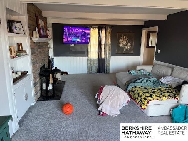 carpeted bedroom with beam ceiling