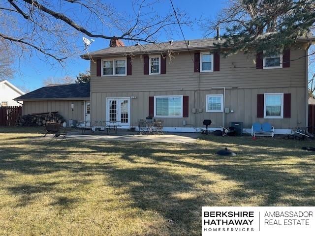 back of property featuring a yard and a patio