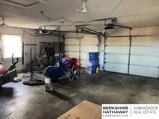 garage featuring ceiling fan and a garage door opener