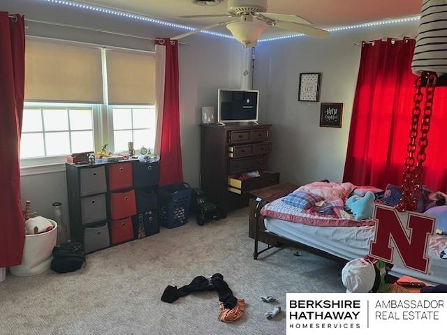 carpeted bedroom featuring ceiling fan