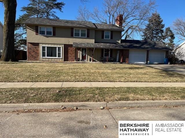 front facade with a front yard and a garage