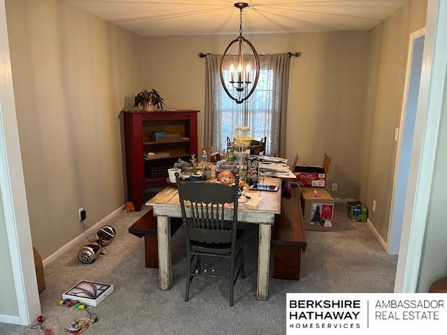 dining area featuring an inviting chandelier and carpet floors