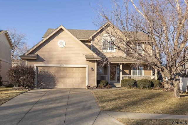 view of front facade with a porch, a front yard, and a garage