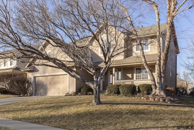 view of front of property featuring a porch, a front lawn, and a garage