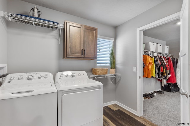 clothes washing area with washer and dryer, cabinets, and dark hardwood / wood-style floors