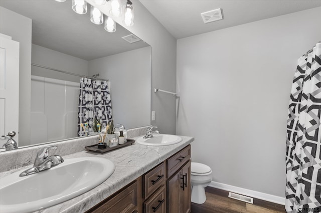 bathroom featuring toilet, a shower with curtain, vanity, and hardwood / wood-style floors