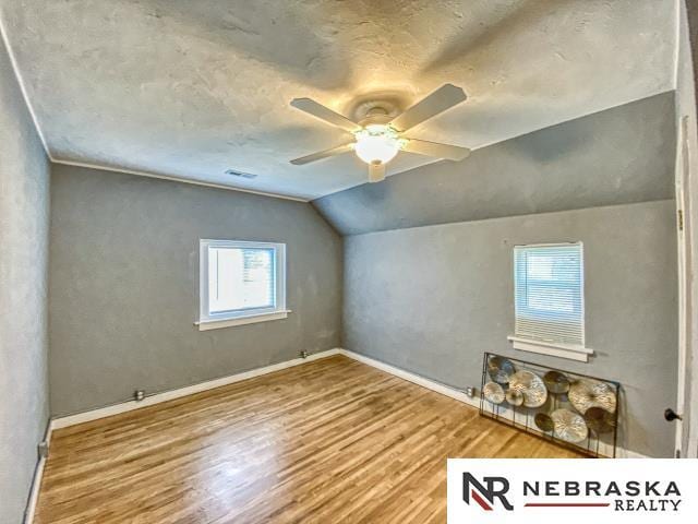 bonus room with ceiling fan, hardwood / wood-style floors, and lofted ceiling