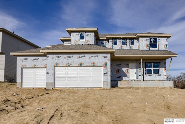 unfinished property with a garage and driveway