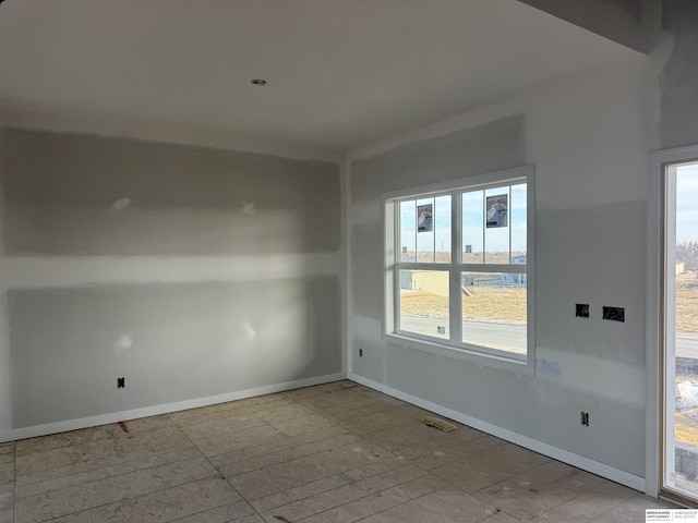 unfurnished room with visible vents and baseboards