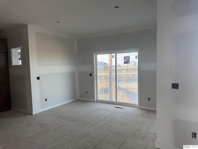 empty room featuring baseboards