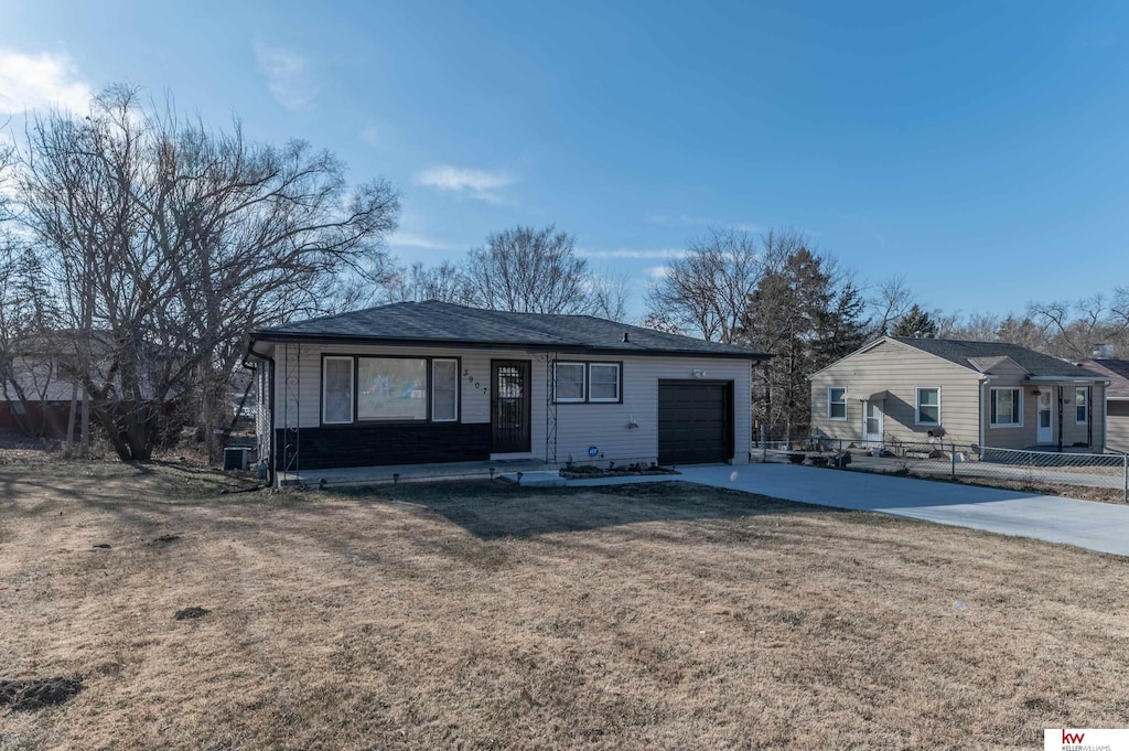 ranch-style house with a garage, covered porch, fence, driveway, and a front lawn