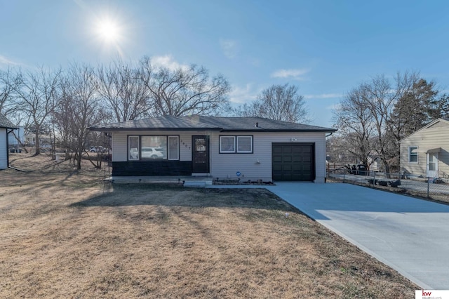 ranch-style house with a front yard and a garage