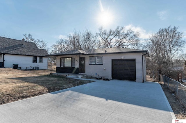 ranch-style house featuring a front yard and a garage