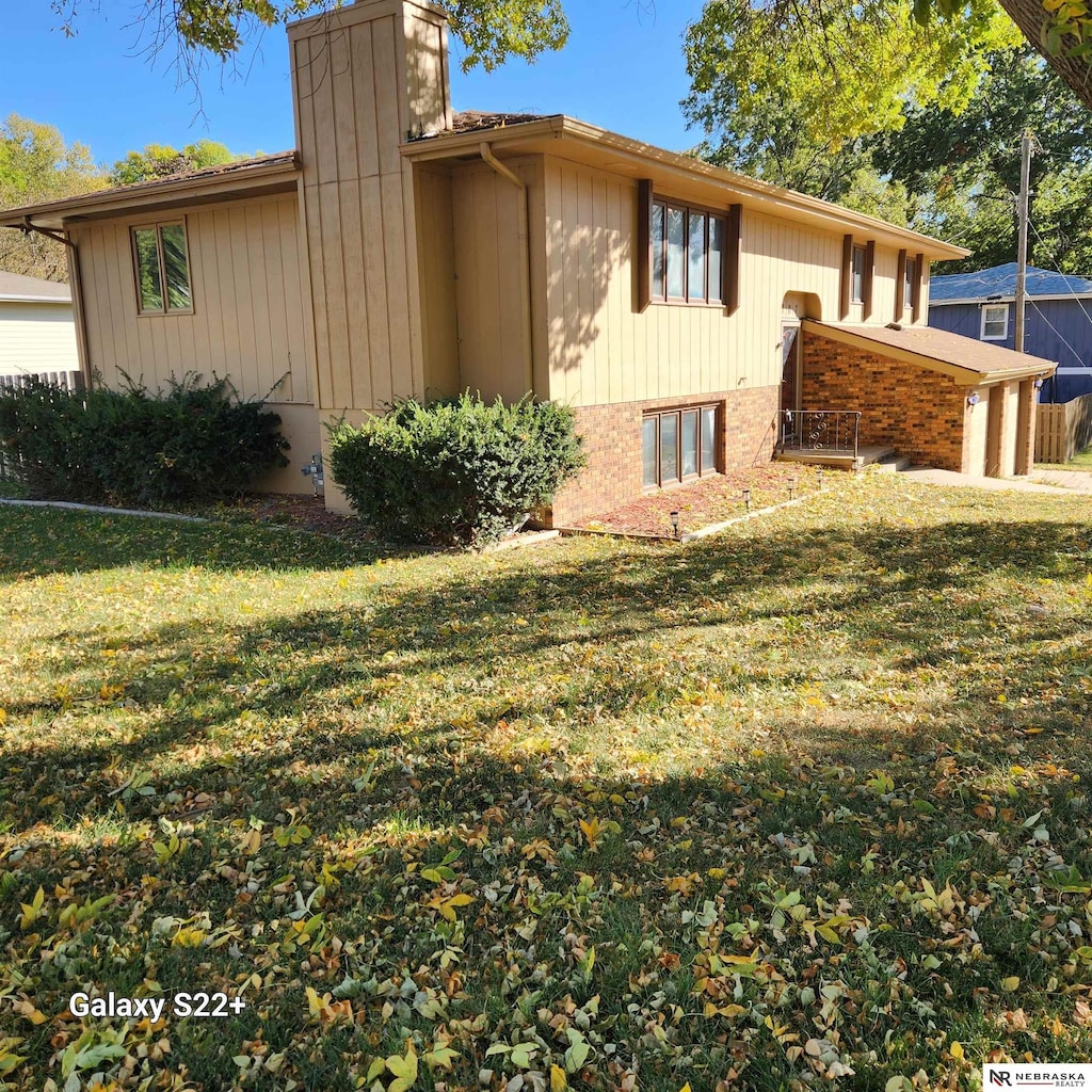 view of property exterior featuring a lawn