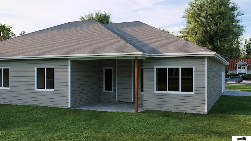 rear view of house with a patio and a yard